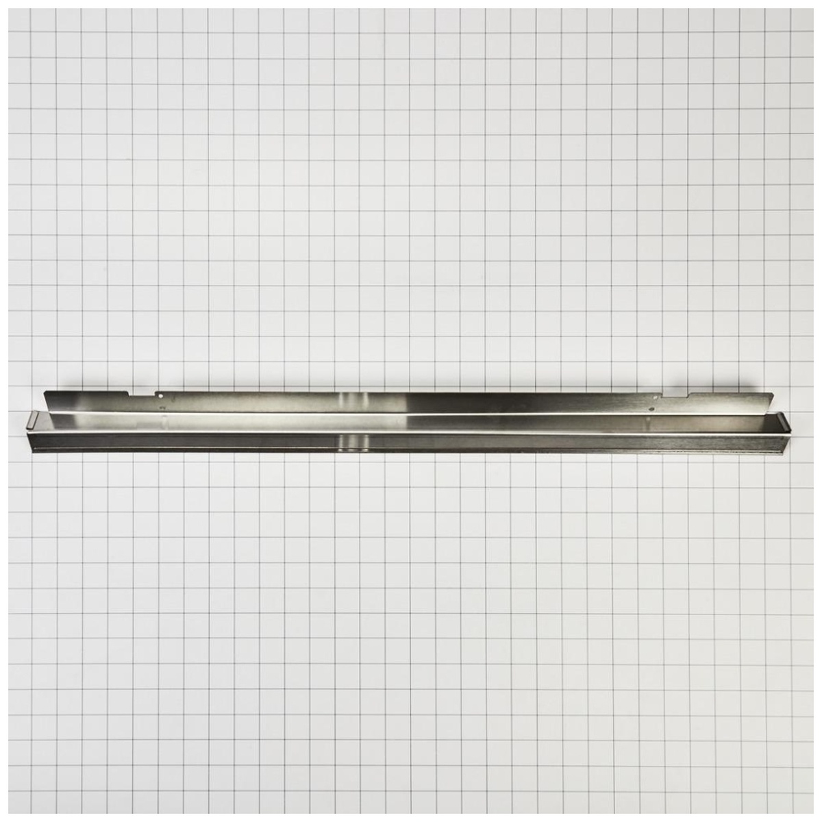 Trim piece showing formed channels and edges on grid surface