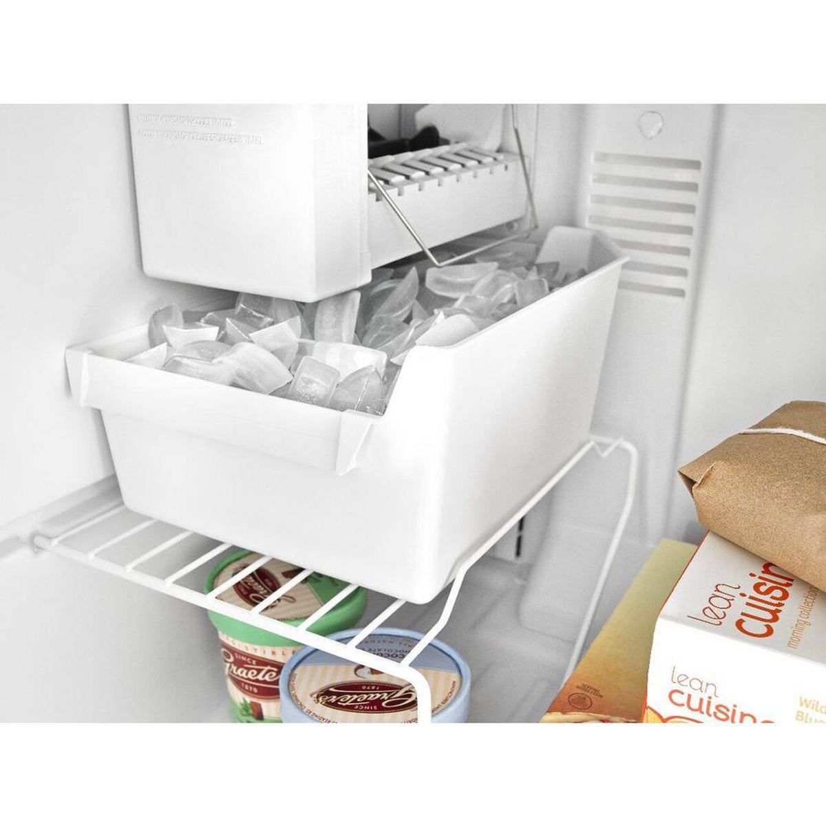 Ice maker installed in a top-freezer refrigerator filling the included ice bin