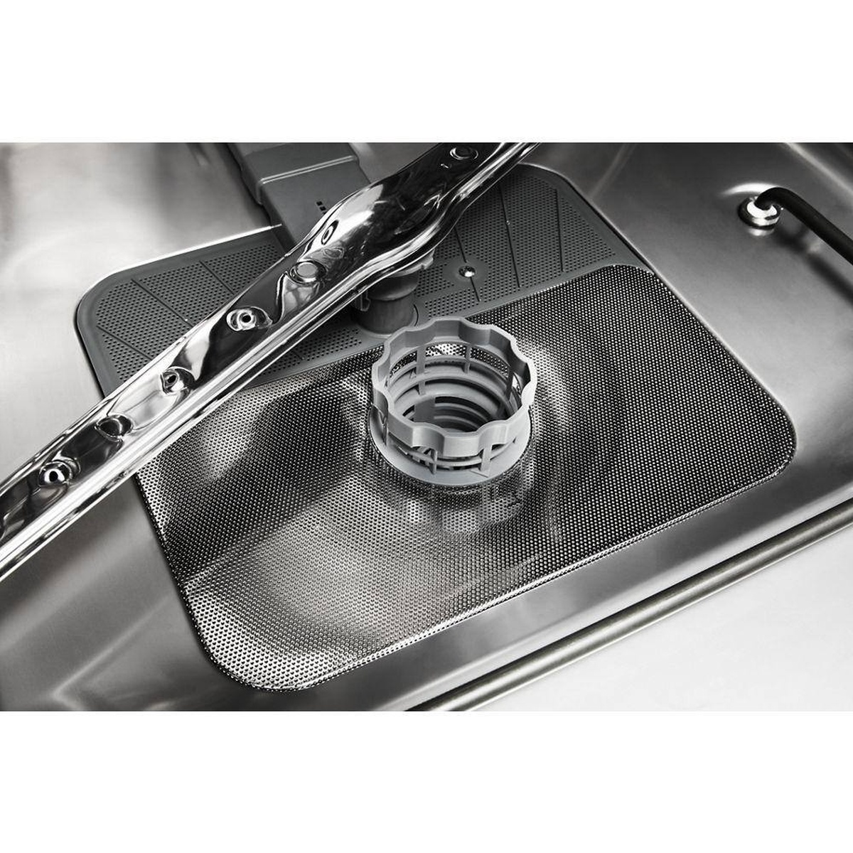 Close-up of hard food filter and spray arm in the stainless tub.