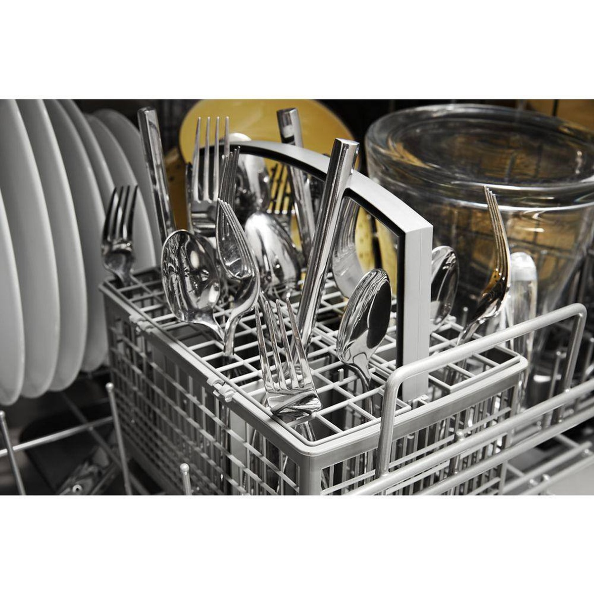 Removable silverware basket loaded with utensils.