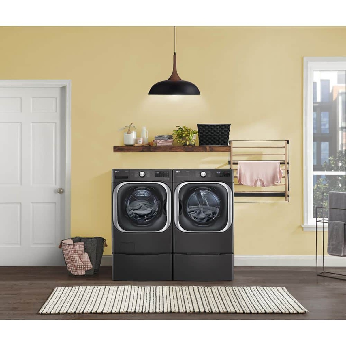 Lifestyle laundry room with LG washer and dryer on matching pedestals