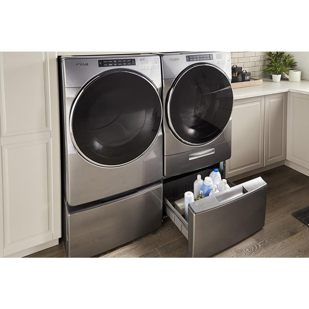 Laundry pair on matching pedestals with drawers holding supplies