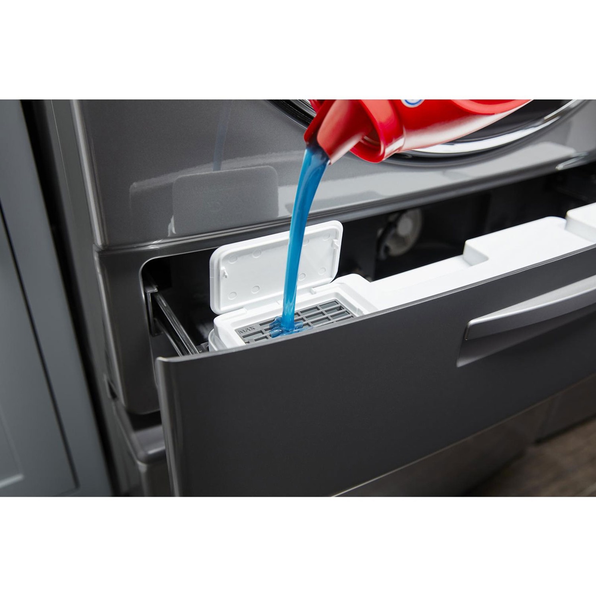 Close-up pouring detergent into the Load & Go XL drawer on the Whirlpool WFW8620HC