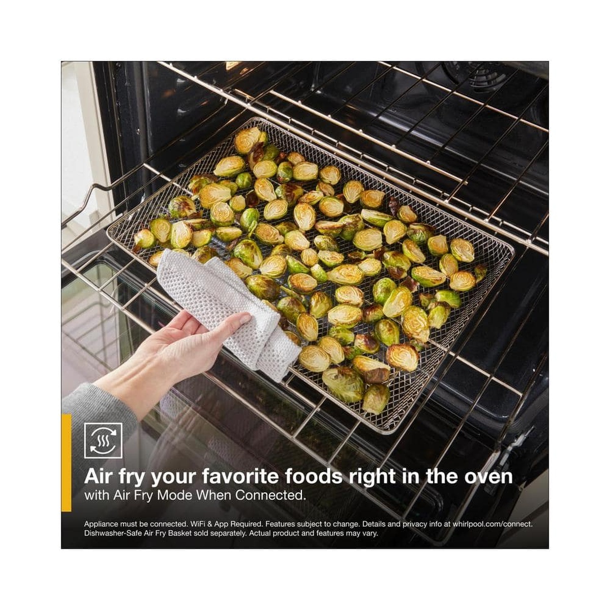 Air Fry basket with roasted Brussels sprouts inside the oven cavity.