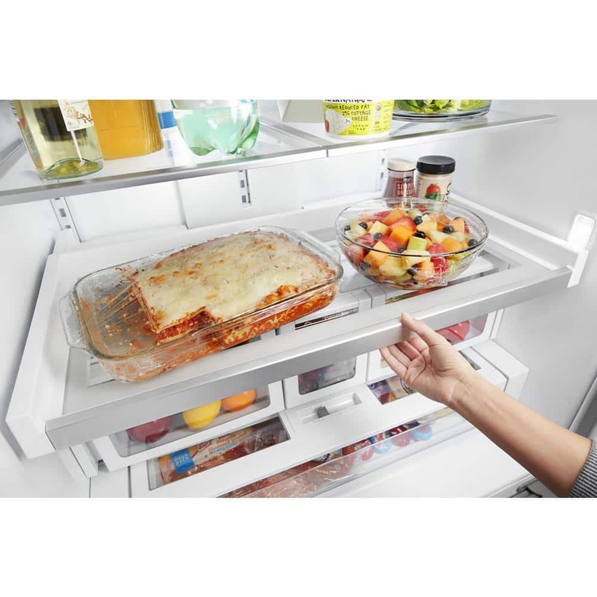 Sliding platter pocket shelf holding casserole and bowls