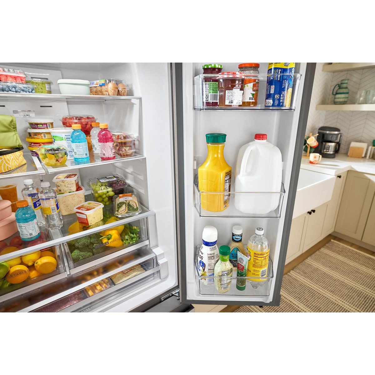 Gallon door bins holding milk and tall bottles inside the Whirlpool French door refrigerator.