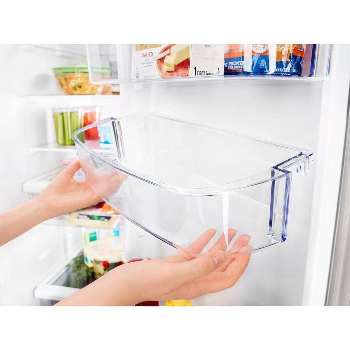 Hands repositioning an adjustable gallon door bin inside the refrigerator door