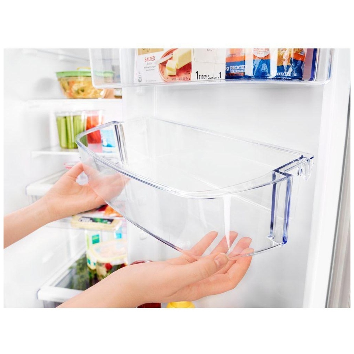 Hands lifting an adjustable clear refrigerator door bin off its mounts.