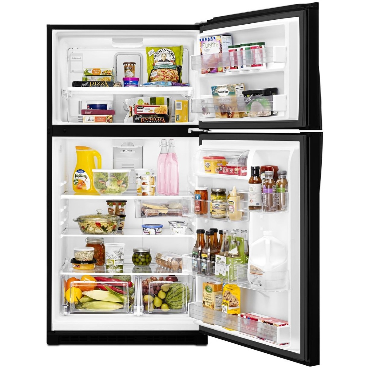 Open Whirlpool top-freezer refrigerator showing shelves, door bins, and crisper drawers filled with groceries