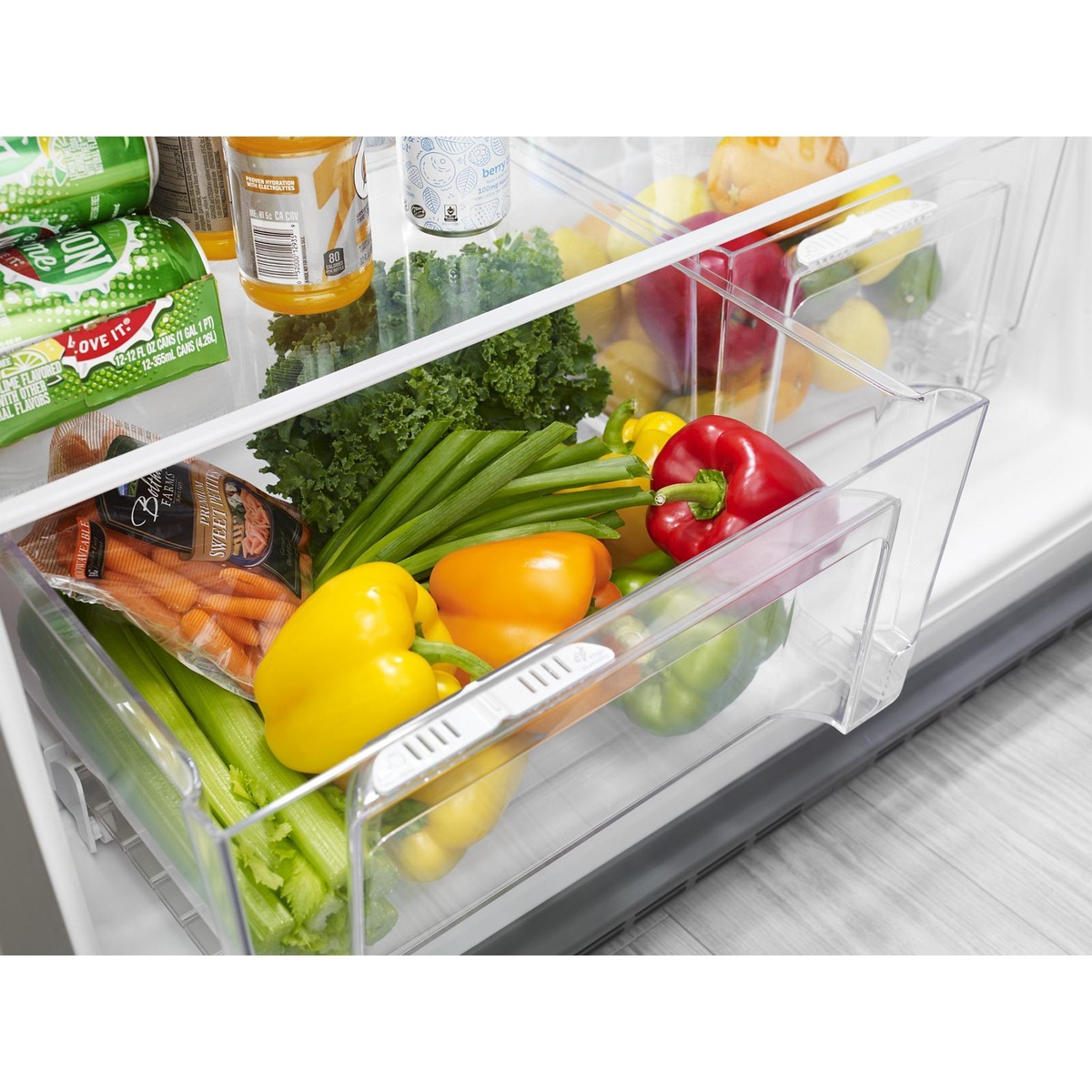 Close-up of humidity-controlled crisper drawers with fresh produce
