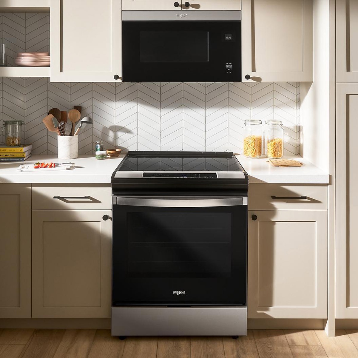 Whirlpool slide-in induction range styled in a modern kitchen alcove.