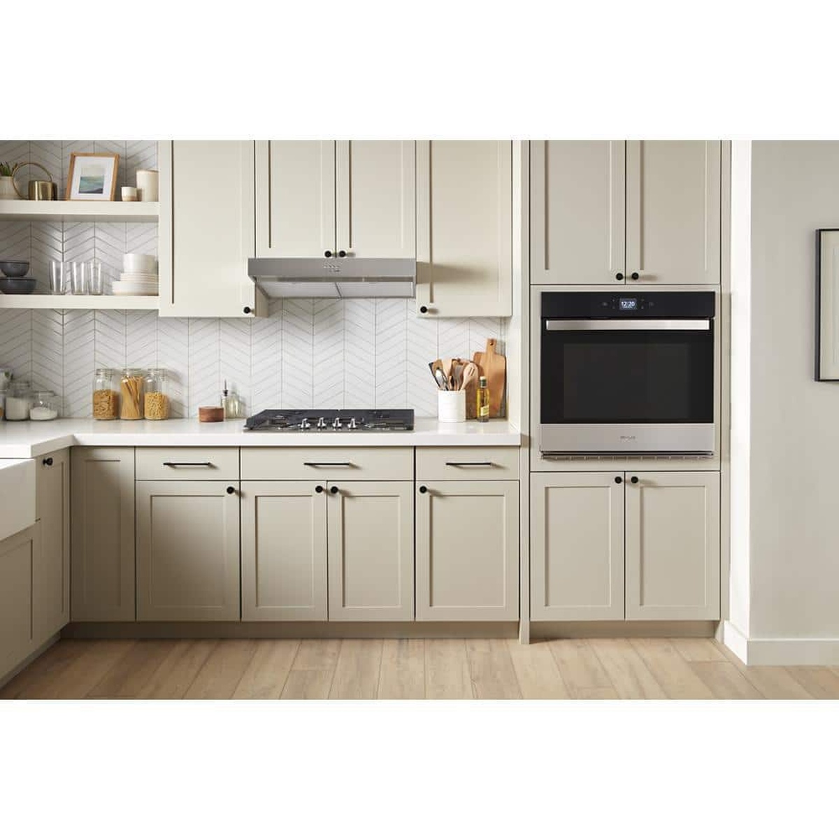 Lifestyle kitchen scene with the hood installed under cabinet above a cooktop