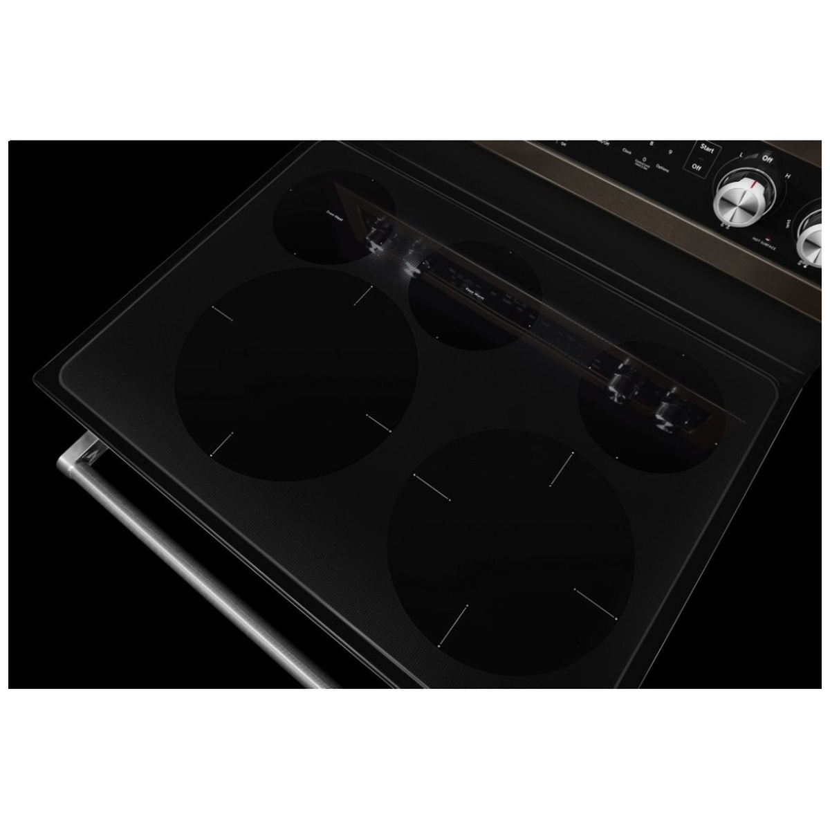 Close-up of black glass cooktop with multiple radiant element zones