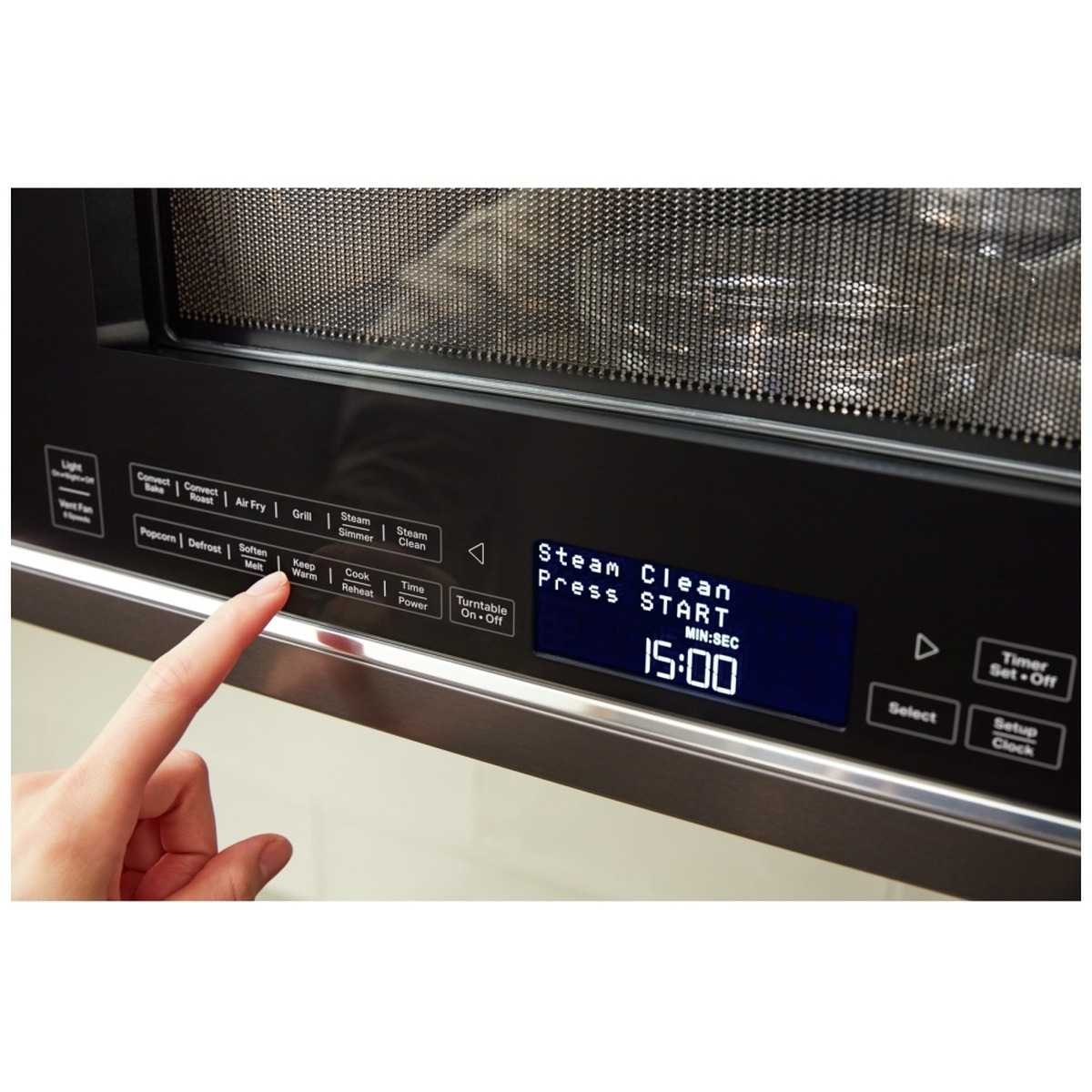 Close-up of the microwave control panel showing Steam Clean on the display