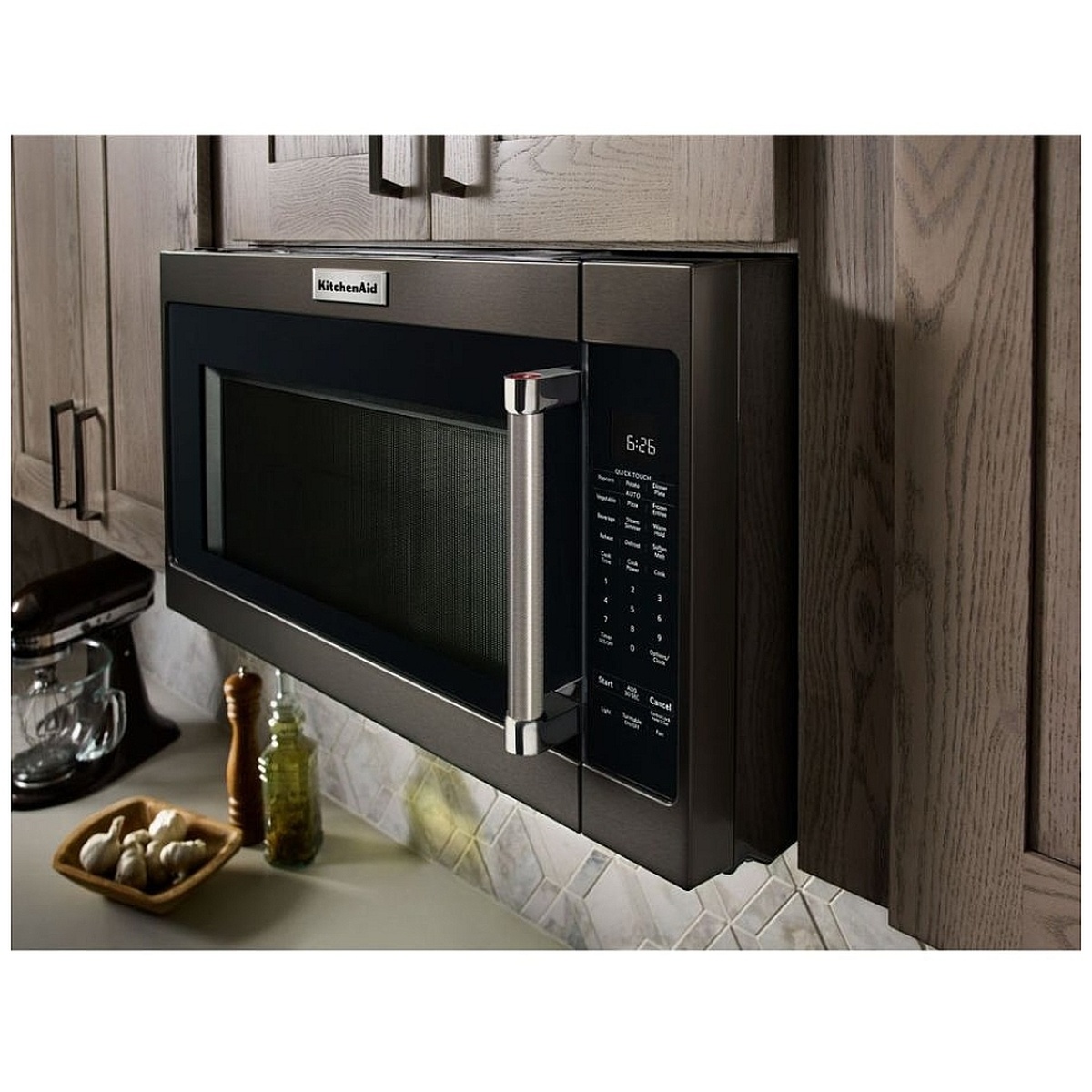 Installed over-the-range microwave close-up showing sturdy handle and black stainless exterior