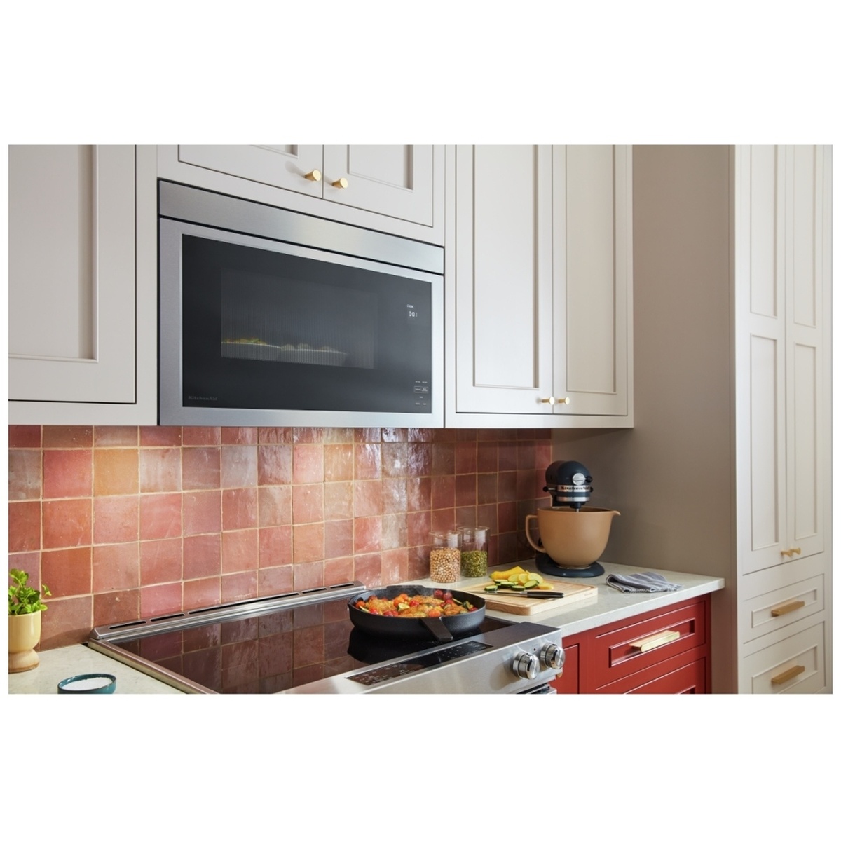 Over-the-range microwave installed above a cooktop in a kitchen