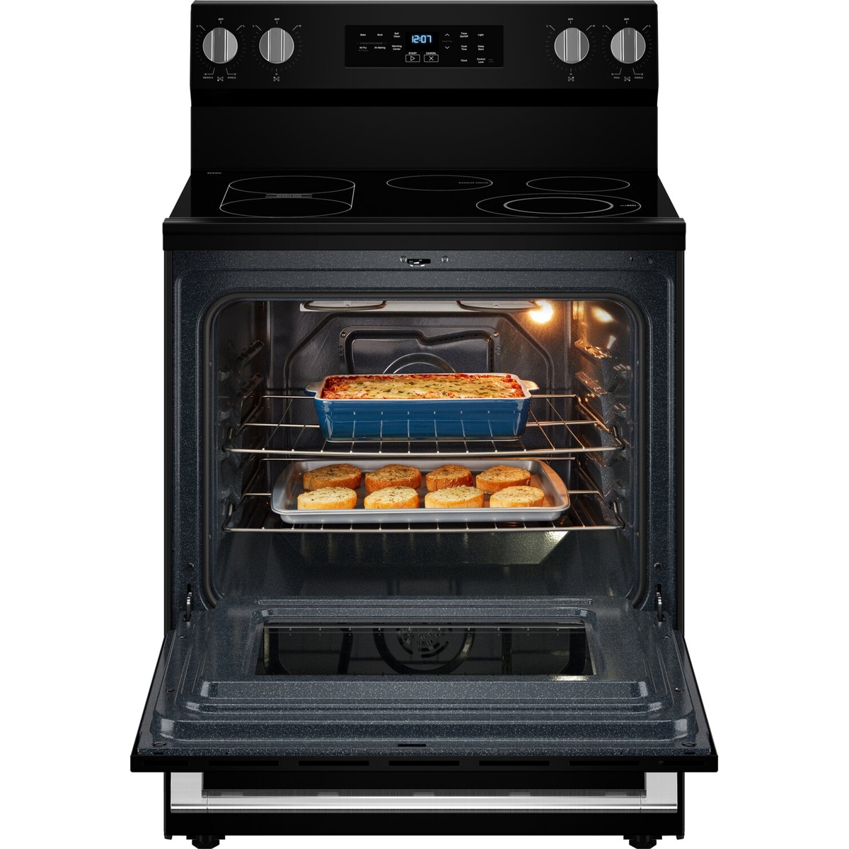 Open oven with two racks loaded with a casserole and biscuits, lit interior showing convection fan.
