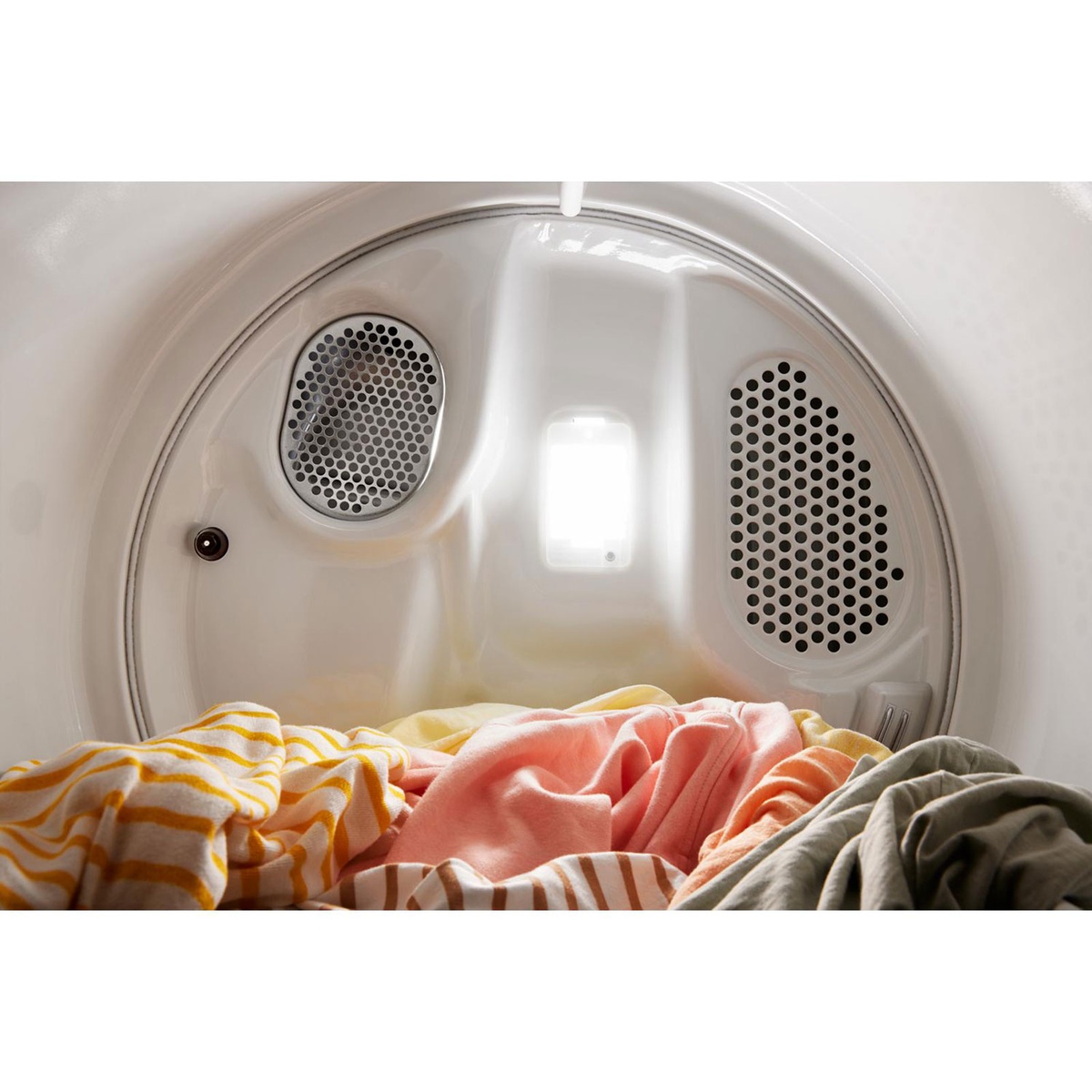 Close-up inside dryer showing vents and light with clothes