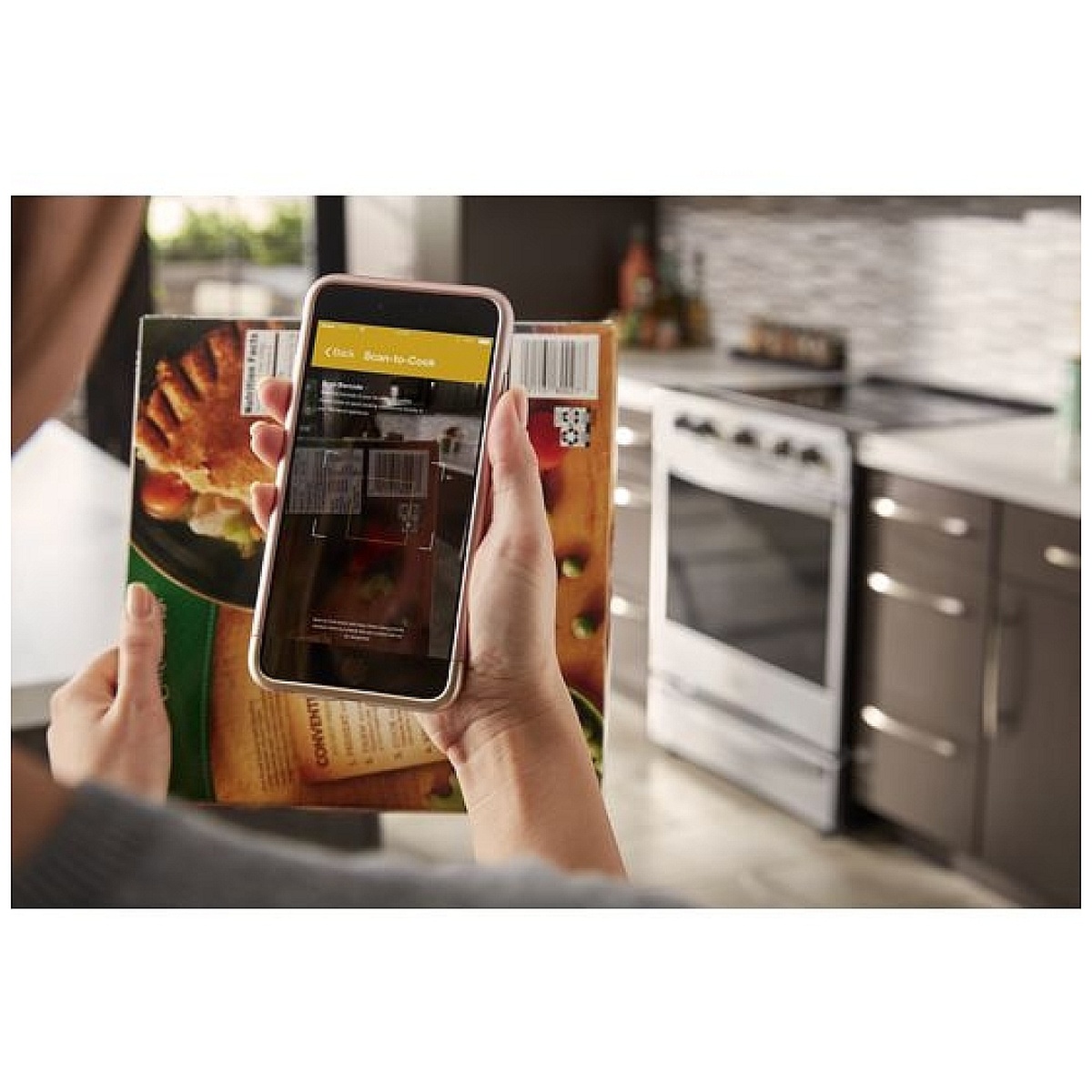 Phone scanning a frozen food barcode in a kitchen with the Whirlpool range in the background