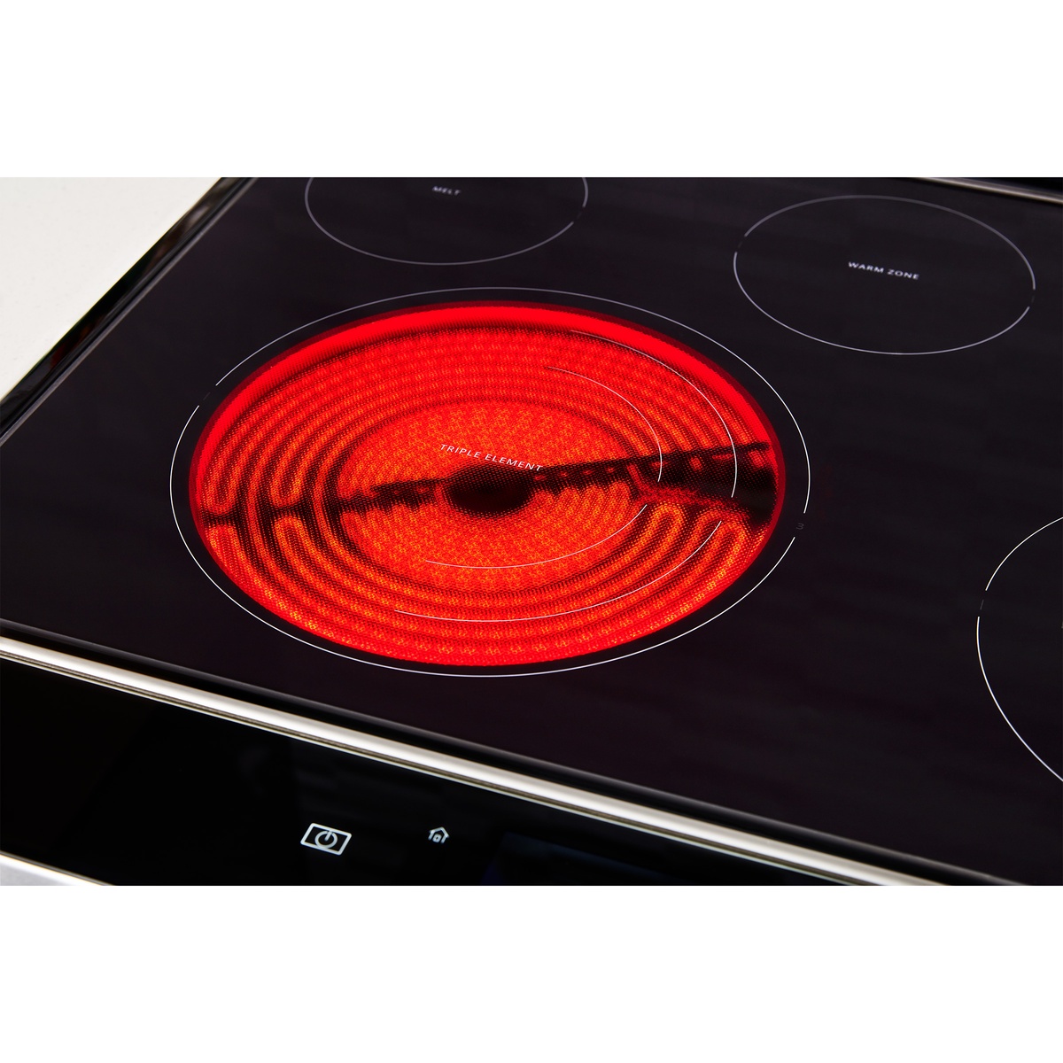 Radiant ceramic glass cooktop with a glowing triple element and marked warm zone.
