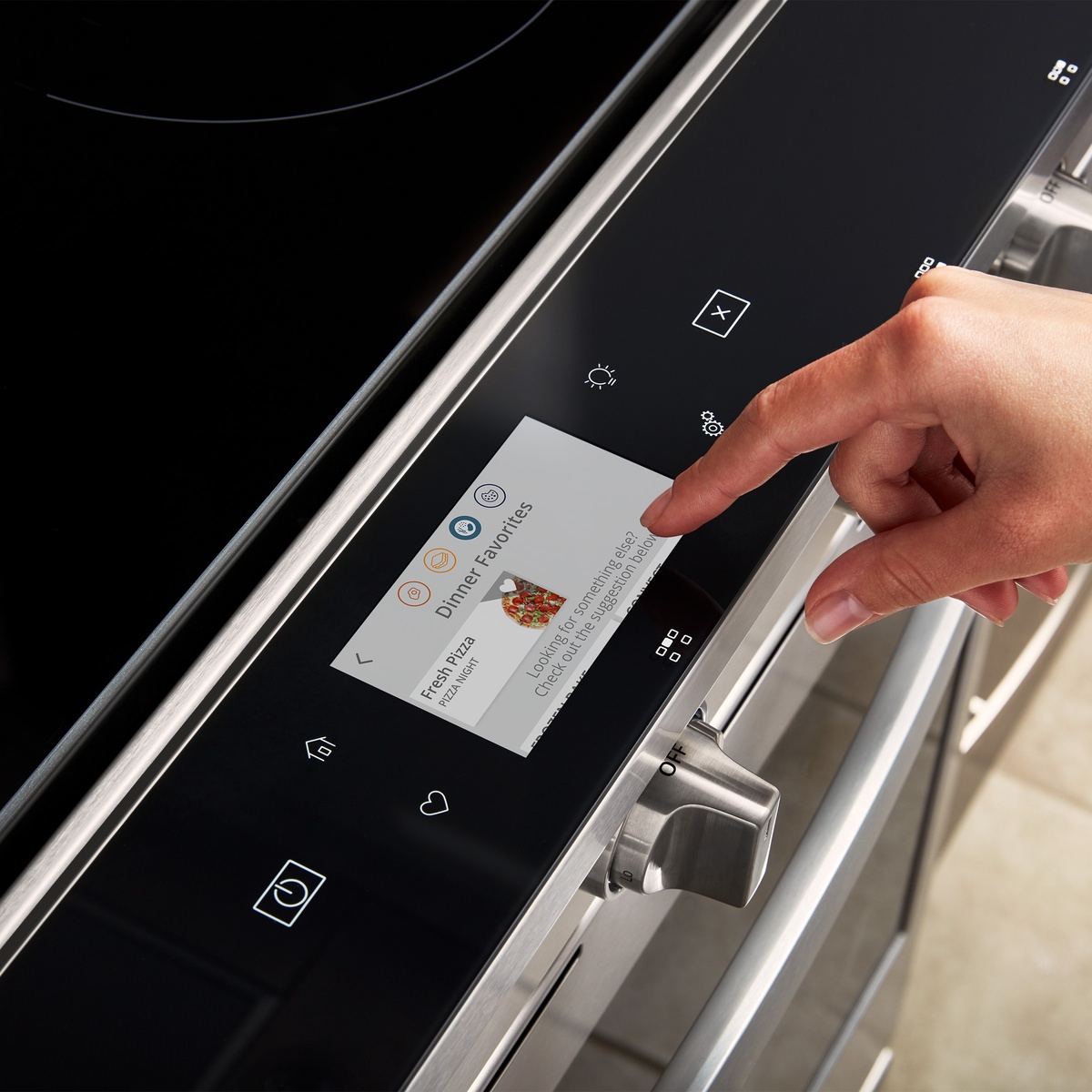 Finger using the Whirlpool range touchscreen with guided cooking options on display.