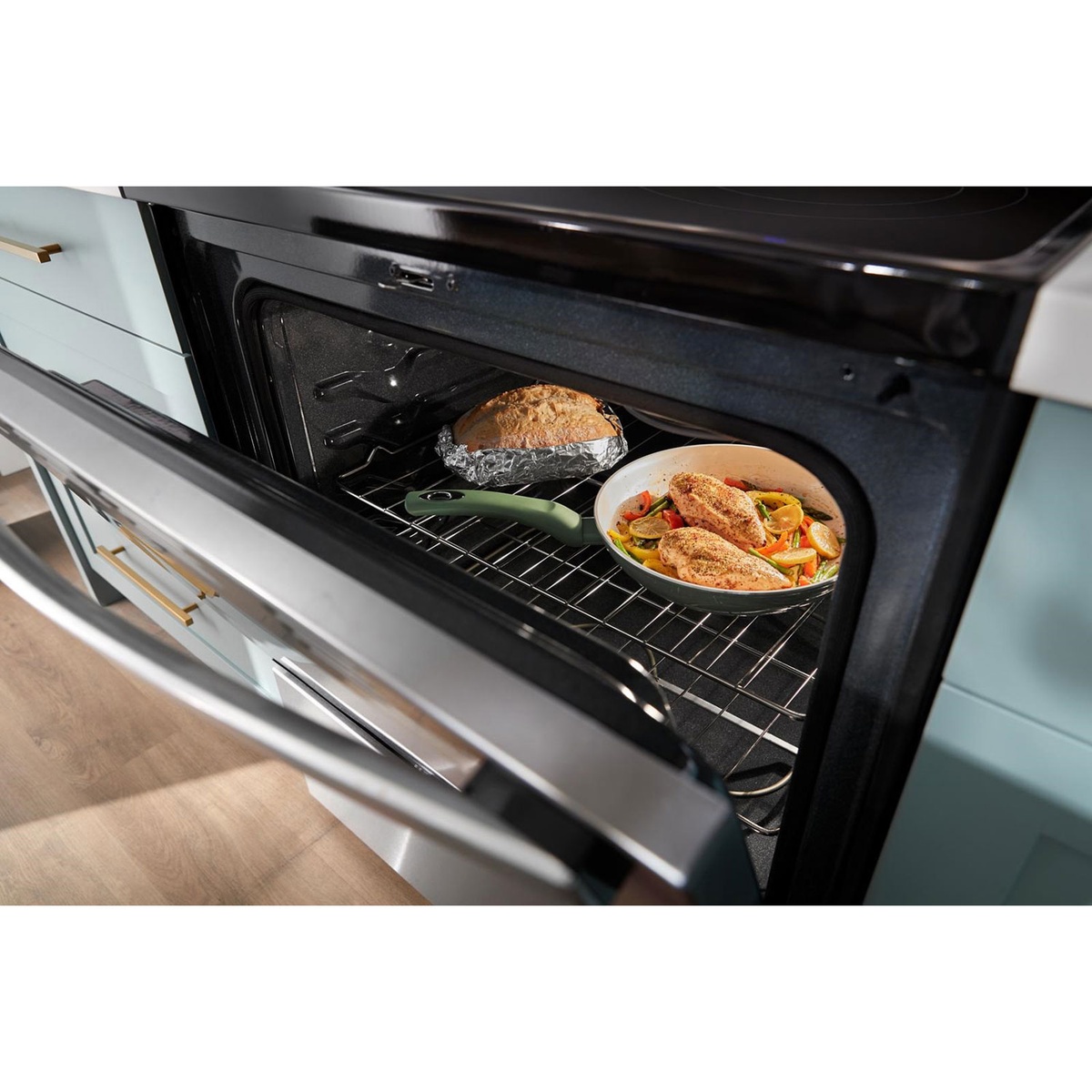 Lifestyle view of the Whirlpool oven with multiple dishes baking inside.