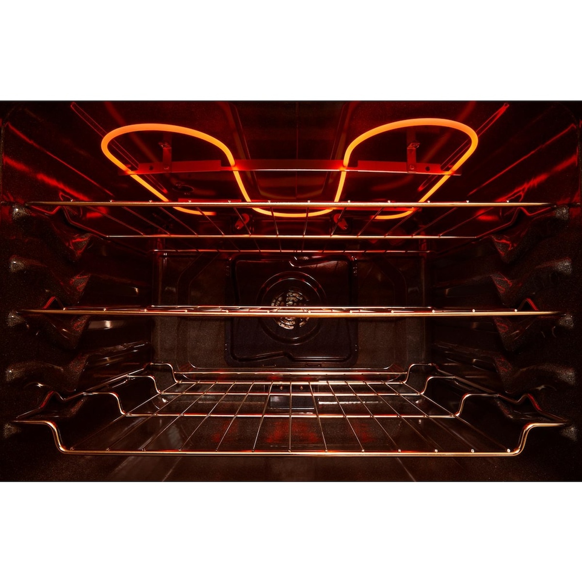 Interior oven view showing glowing broil element and convection fan