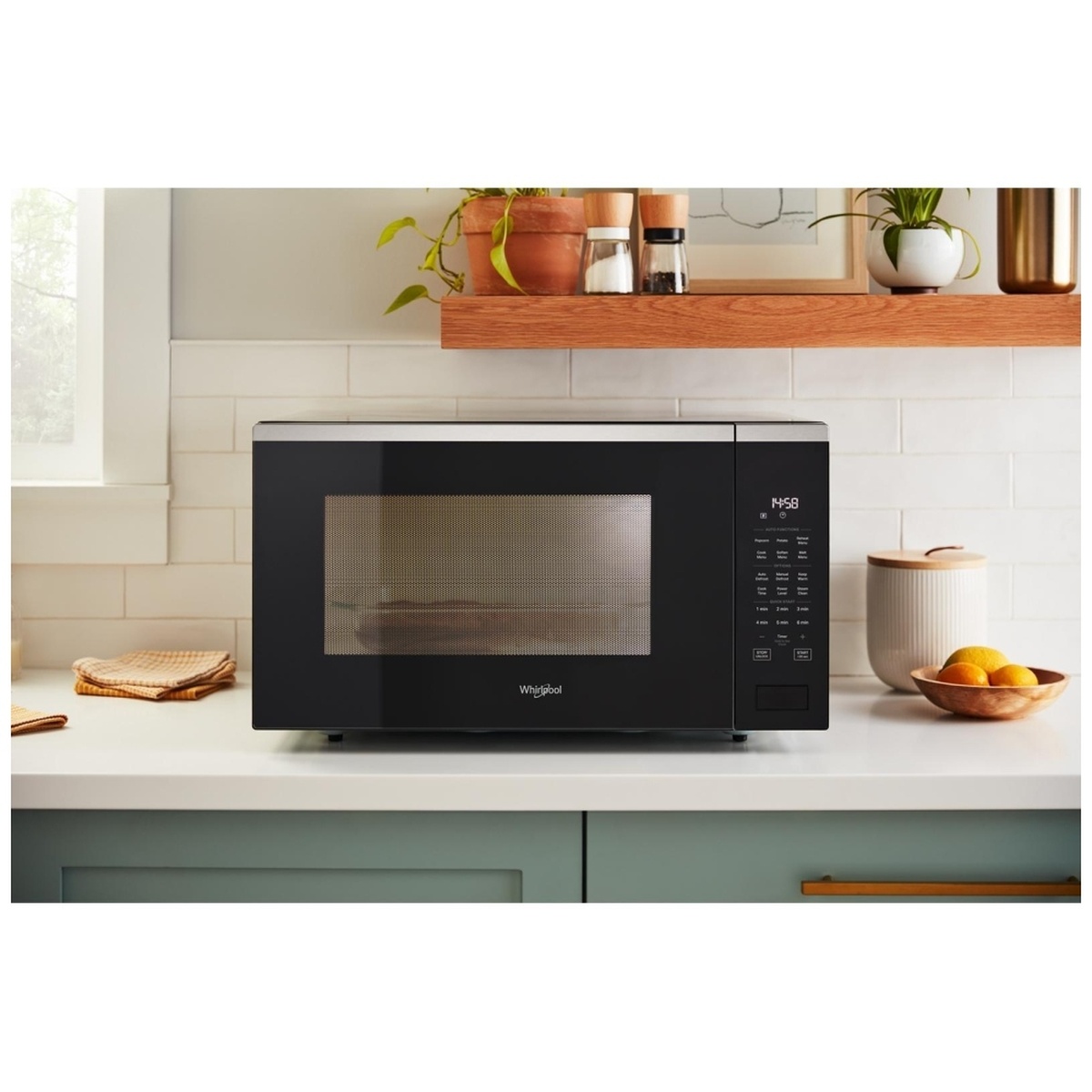 Black Whirlpool countertop microwave styled on a kitchen counter