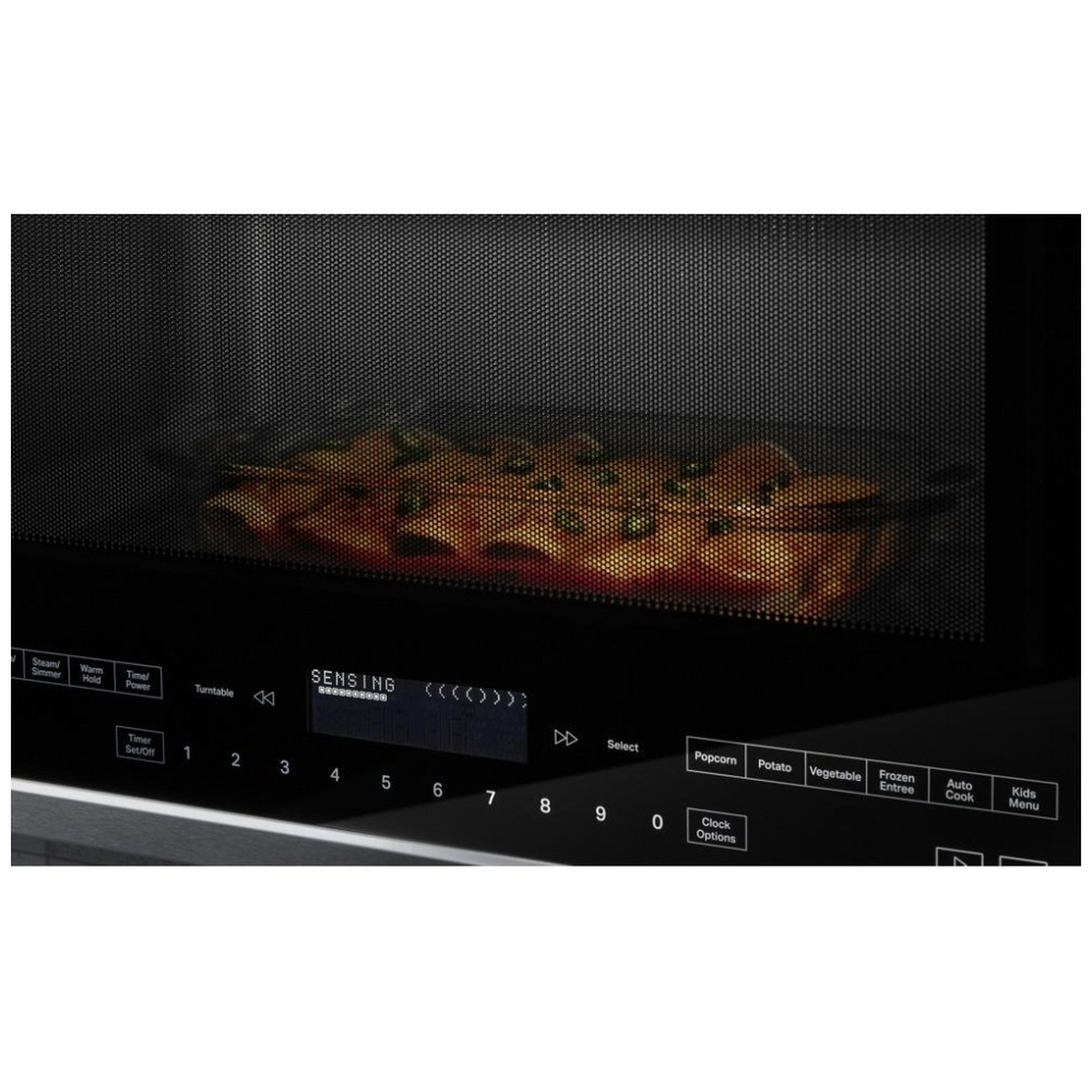 Food cooking inside the microwave with sensing indicator shown on the display