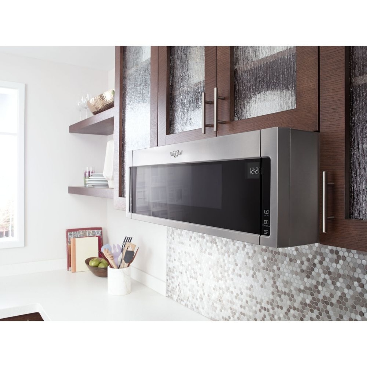 Low-profile Whirlpool over-the-range microwave installed flush under cabinets in a modern kitchen.