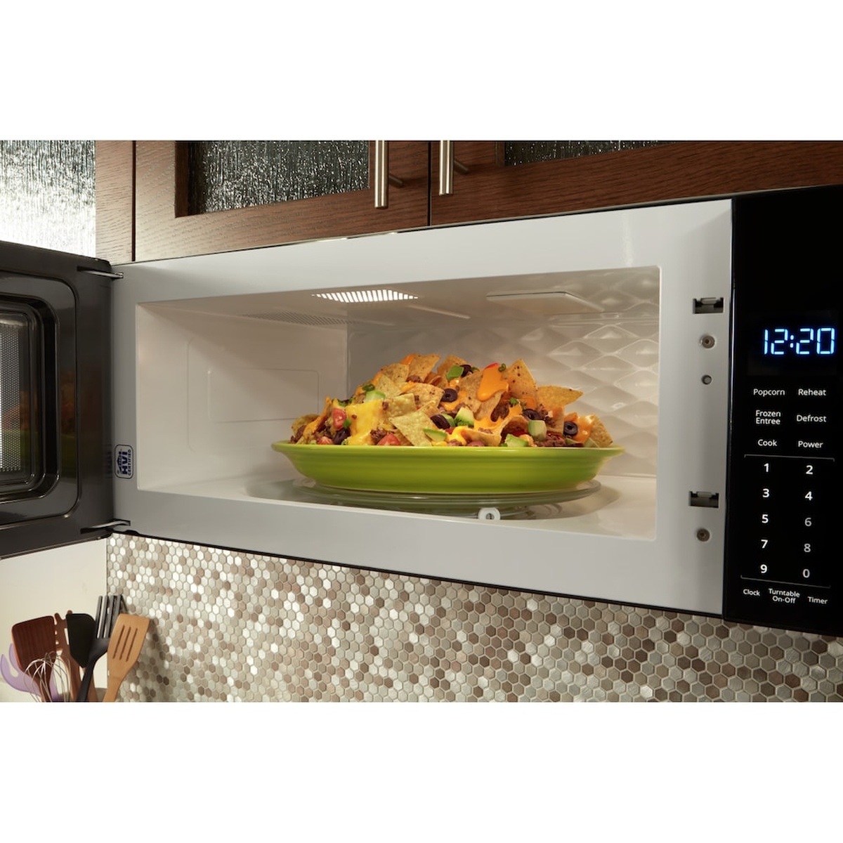 Interior shot with a full dinner plate on the glass turntable inside the microwave.