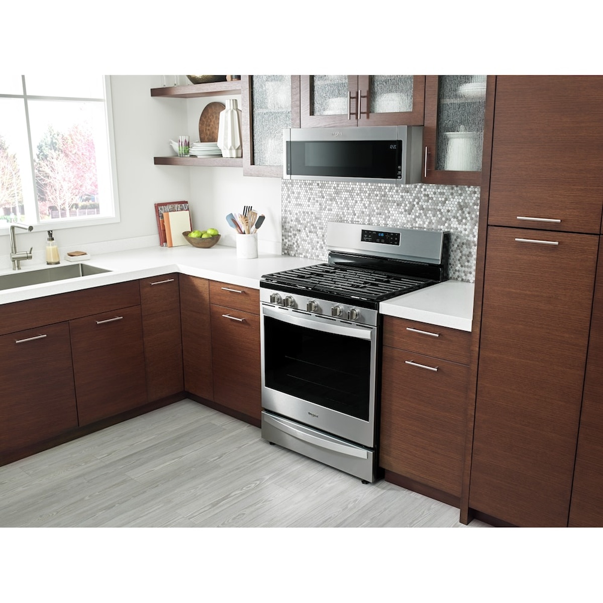 Microwave venting above a range in a real kitchen setting.