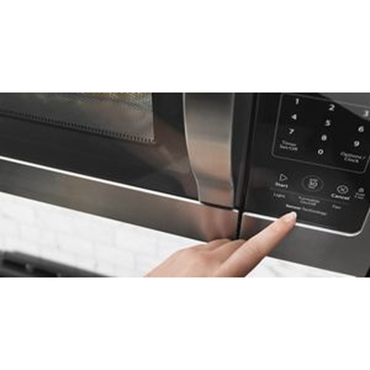 Close-up of the microwave touch controls being pressed