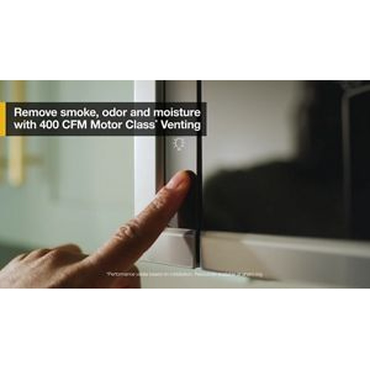 Hand tapping the microwave door area in a kitchen