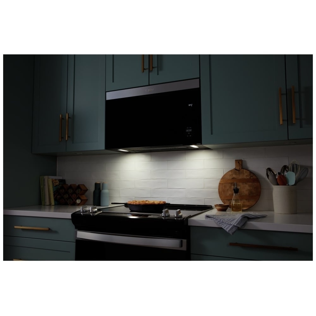 LED cooktop lights illuminating the range below the microwave