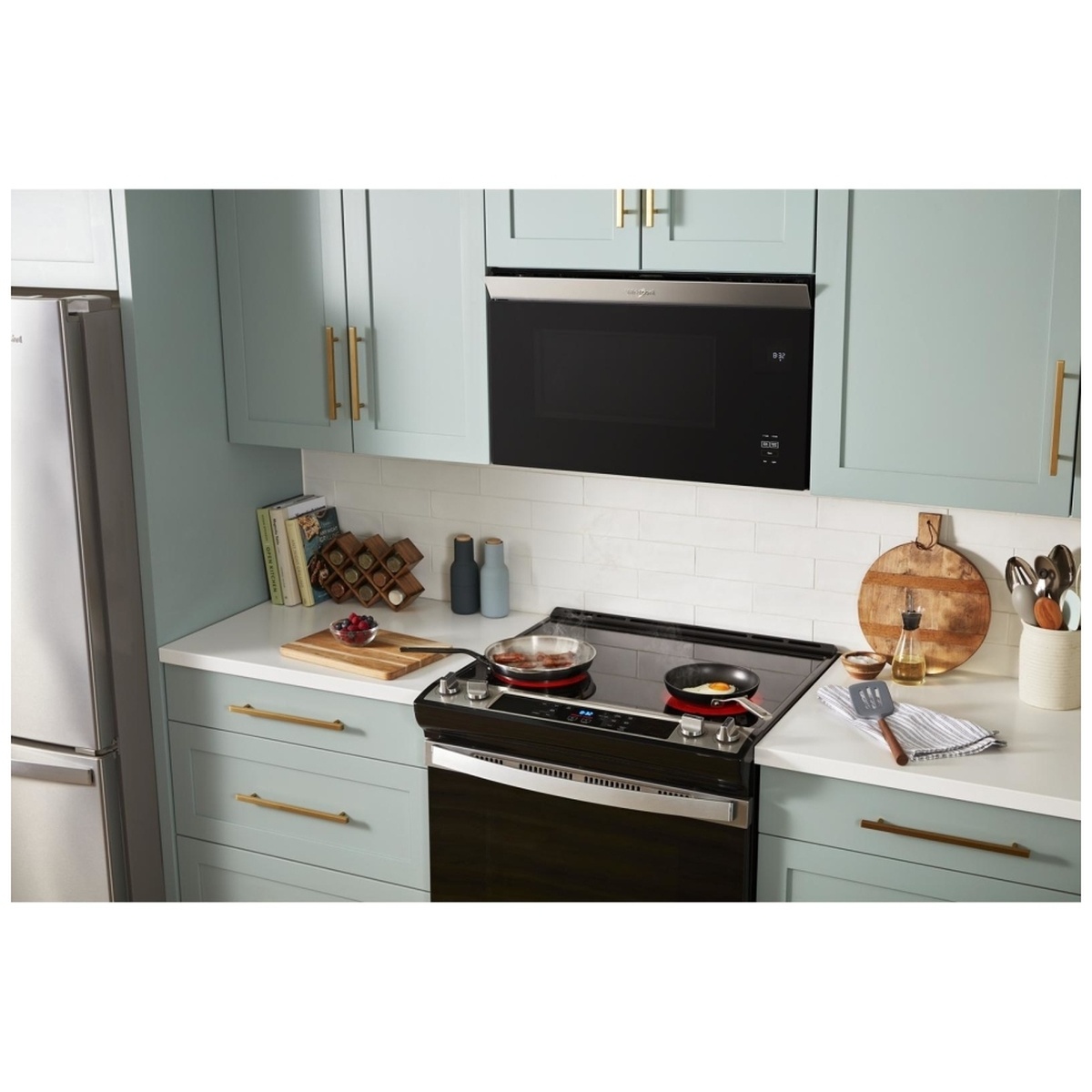 Microwave installed flush above a range in a modern kitchen