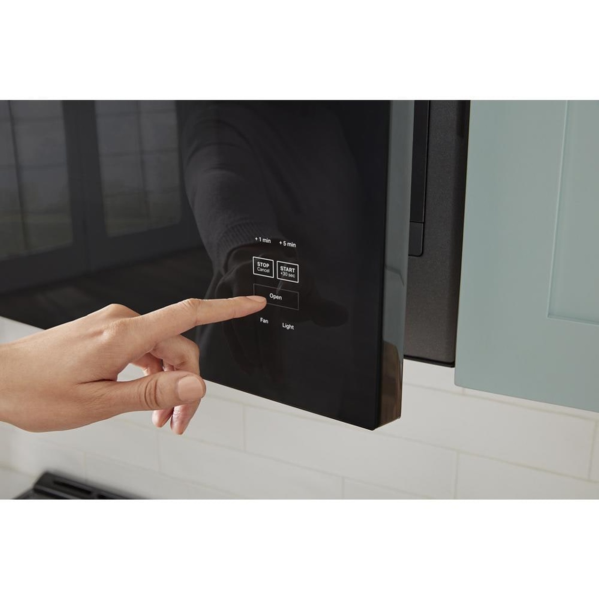 Tap-to-open control being pressed on the microwave door