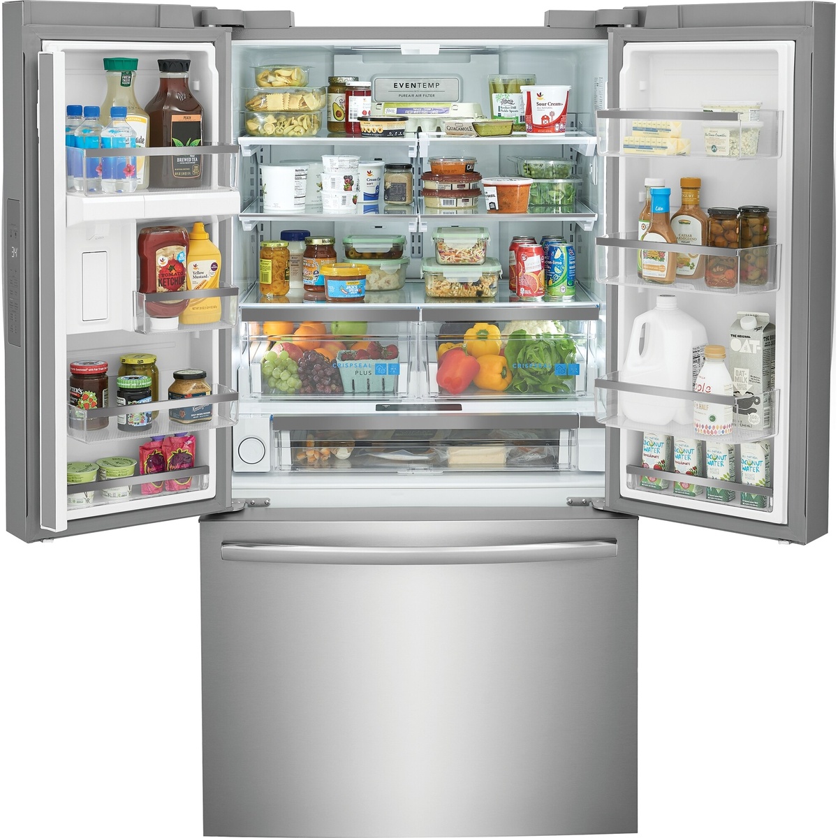Open Frigidaire French door refrigerator filled with food, showing adjustable glass shelves, door bins, CrispSeal Plus crispers, and a wide center drawer