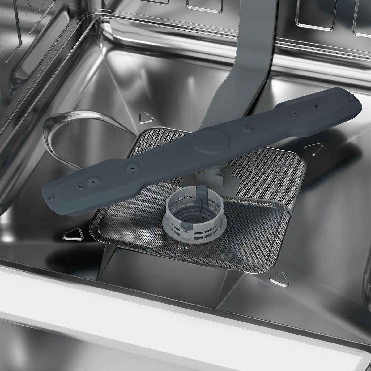 Close-up of a dishwasher stainless steel tub with the lower spray arm and filter area