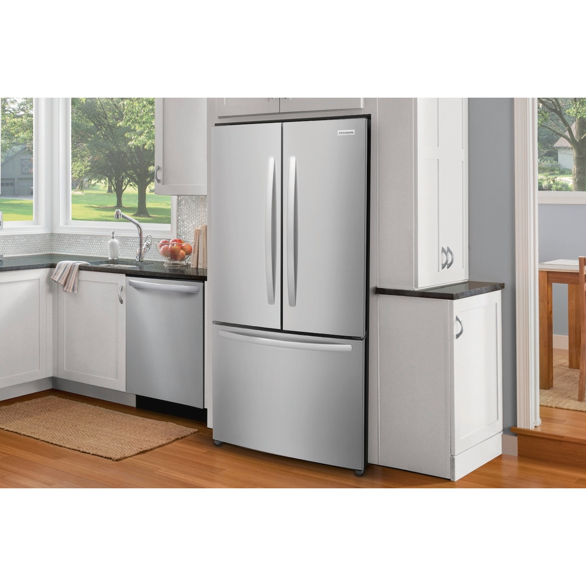 Stainless-look counter-depth French door refrigerator installed in a bright kitchen