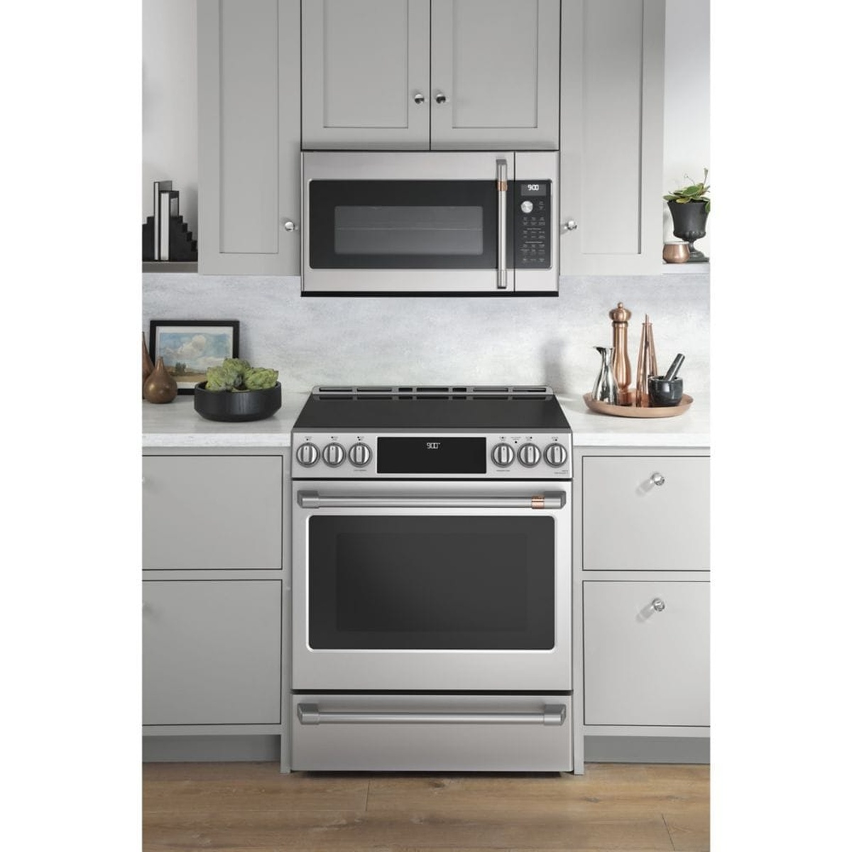 Café slide-in range installed in a modern kitchen with matching cabinetry and a wall-mounted microwave above