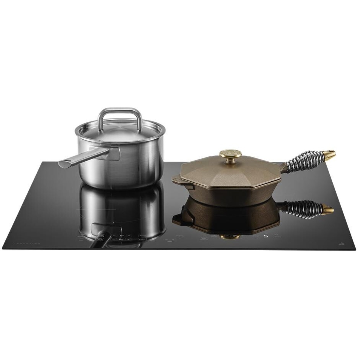 Pots and cookware sitting on a black glass JennAir induction cooktop