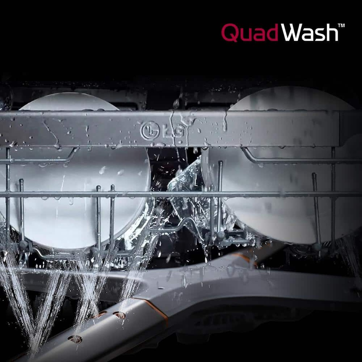 Close-up of dishes being sprayed with water inside an LG dishwasher with QuadWash logo