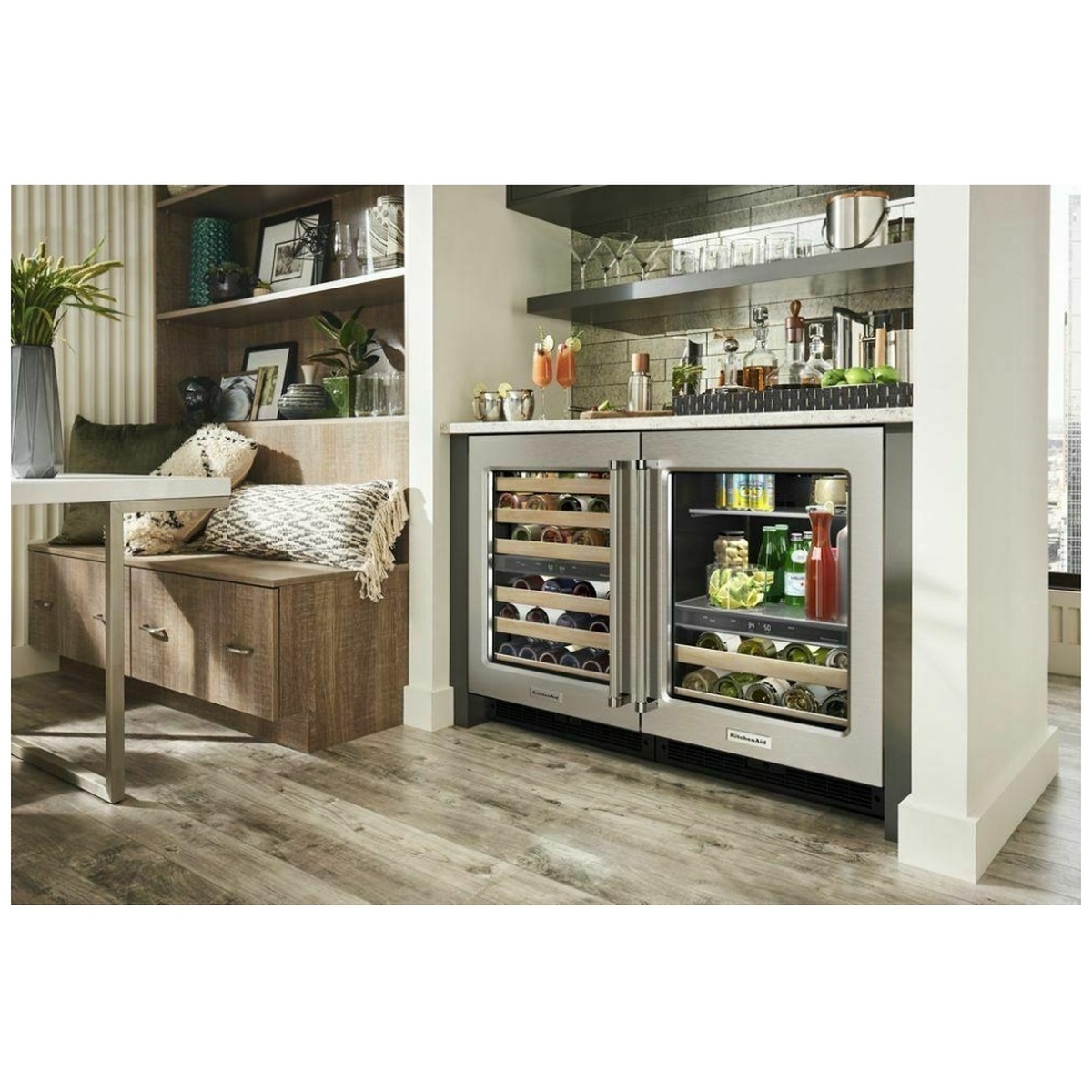 Undercounter KitchenAid beverage center installed in a kitchen island next to a matching wine unit