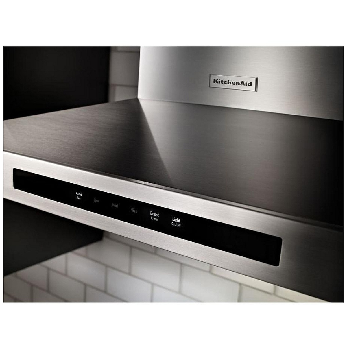 Close-up of the KitchenAid wall-mount range hood touch control panel showing auto fan, multiple fan speeds, boost, and light controls