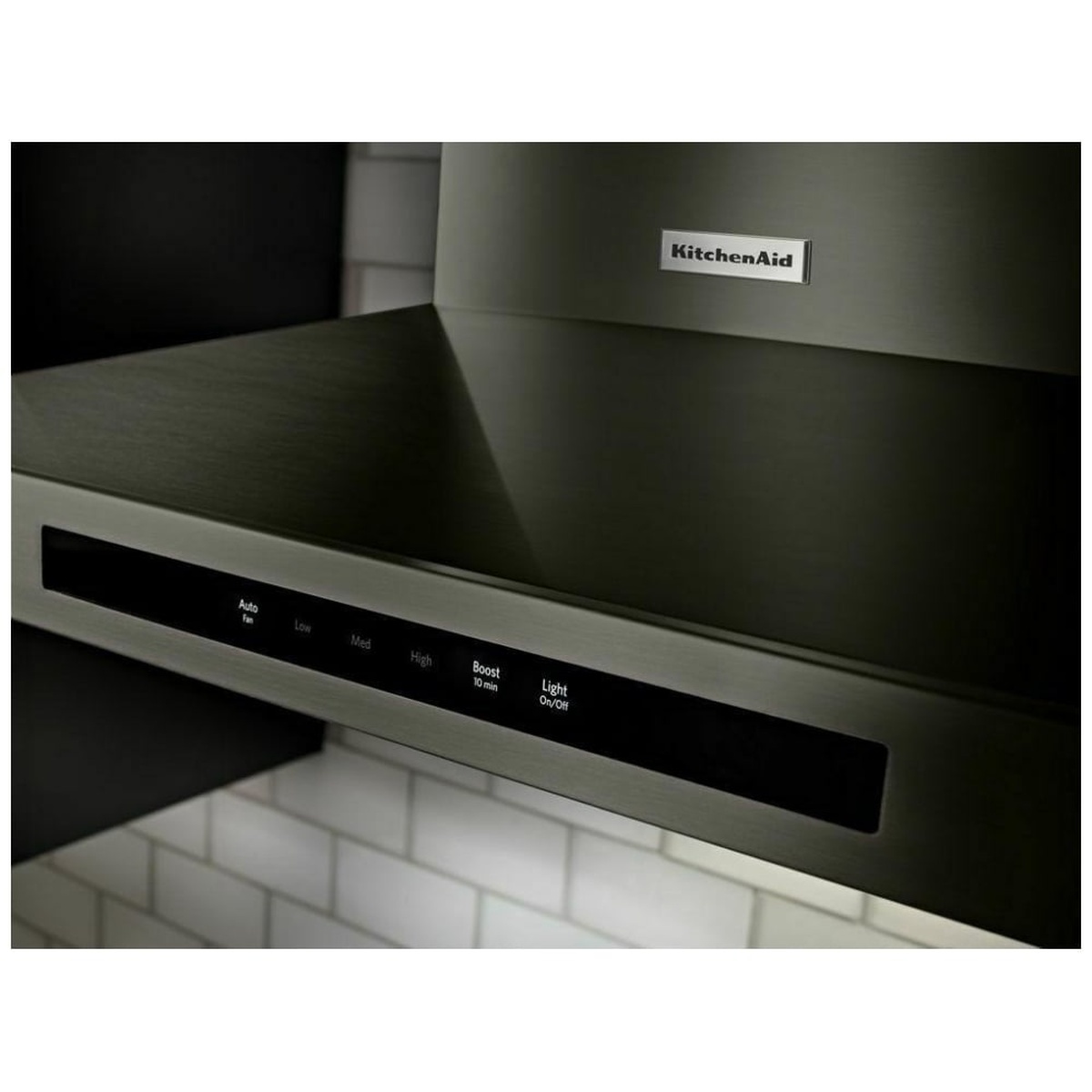 Close-up of the KitchenAid wall-mount hood showing the front glass touch control strip with Auto, Low, Med, High, Boost, and Light On/Off labels