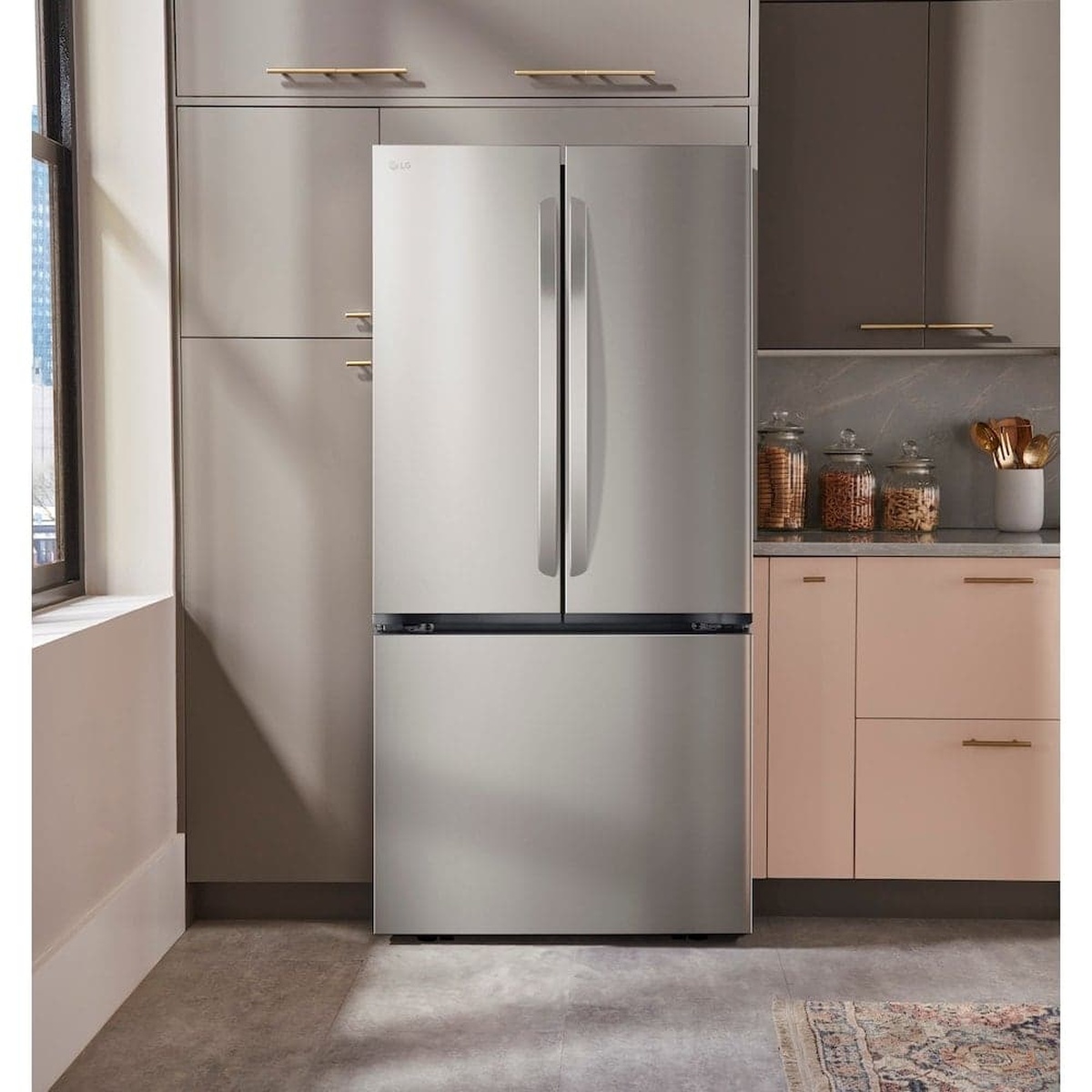 LG counter-depth stainless steel refrigerator installed between kitchen cabinets
