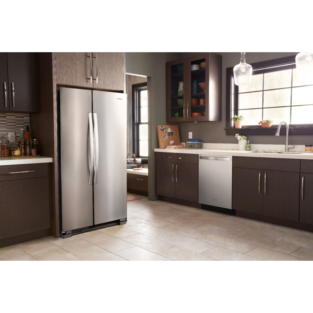 Whirlpool stainless steel side-by-side refrigerator installed in a modern kitchen