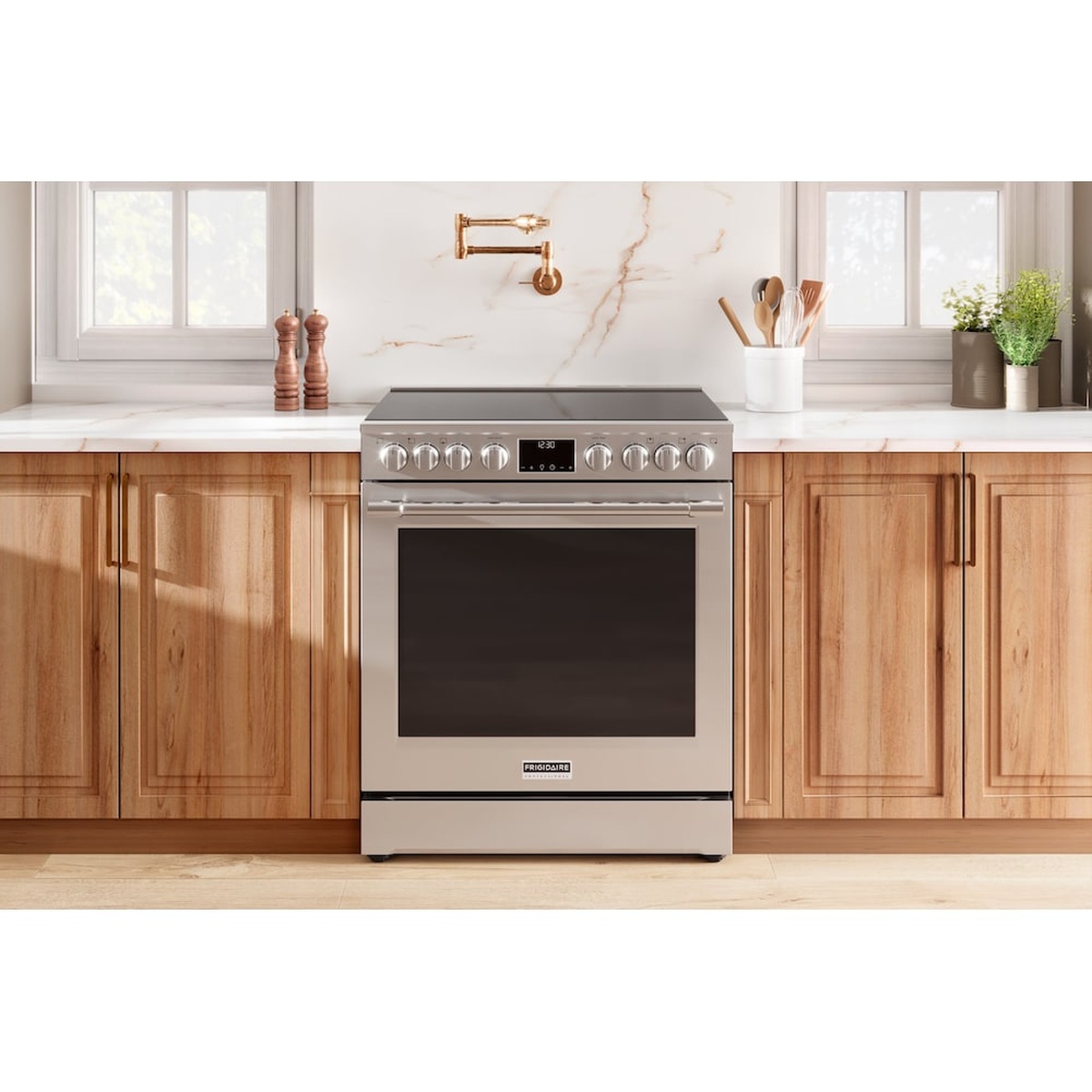 Frigidaire Professional slide-in electric range installed between wooden cabinets in a bright kitchen