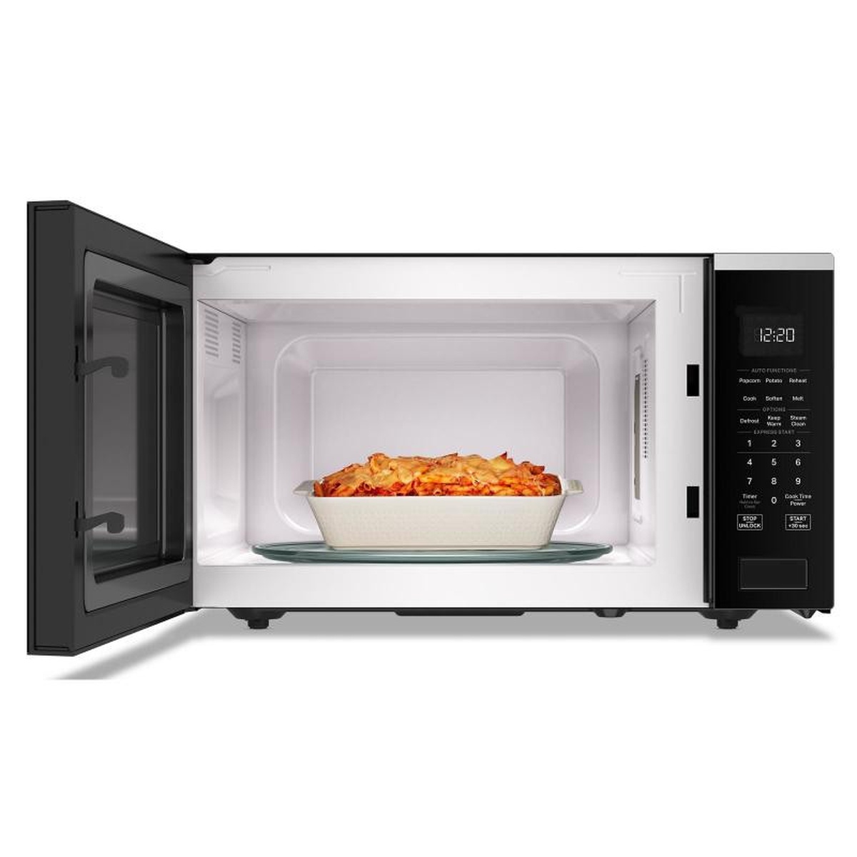 Whirlpool countertop microwave with the door open, showing the interior cavity and glass turntable with a baking dish